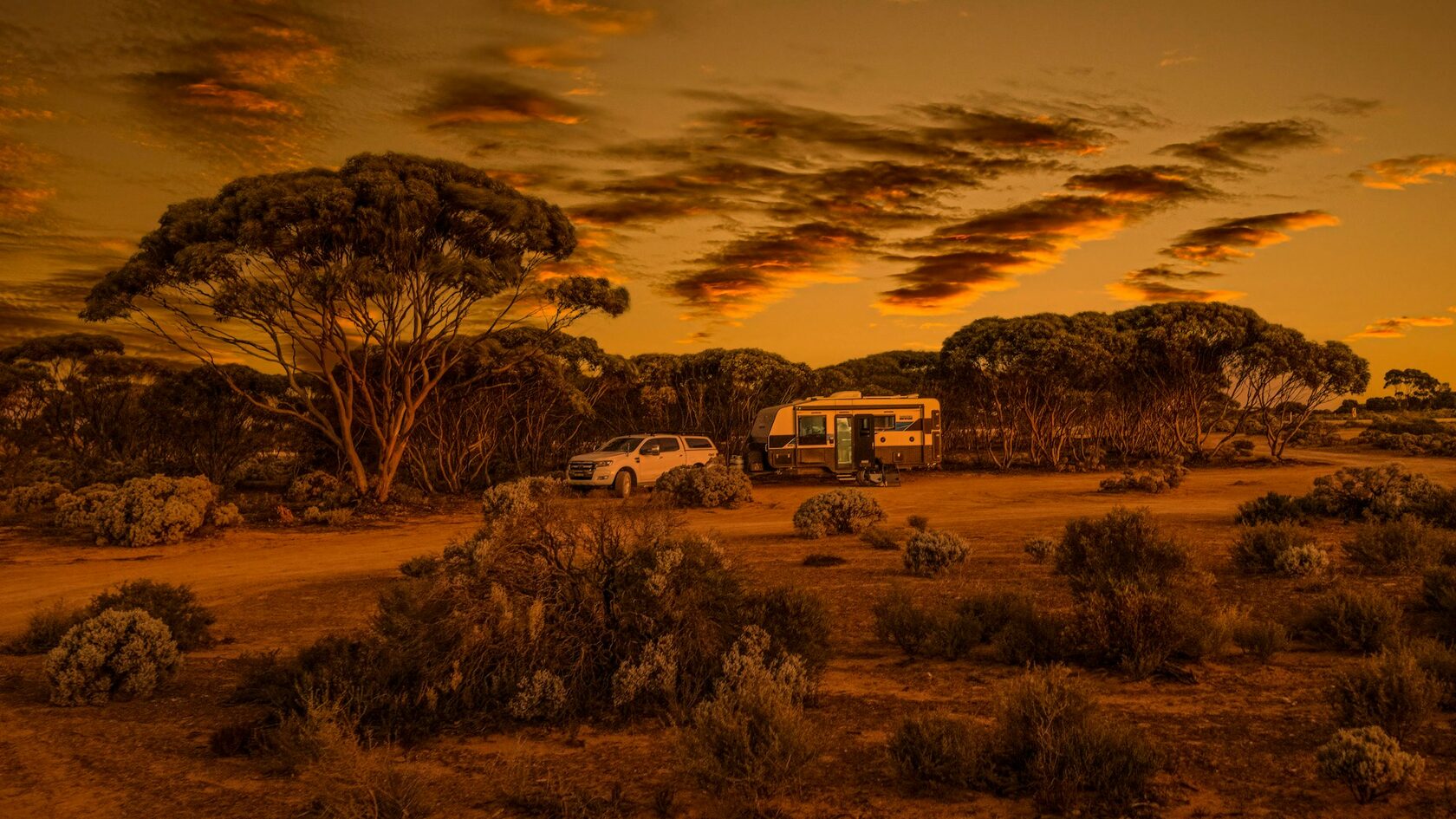 A caravan site pitched in a clearing surrounded by trees